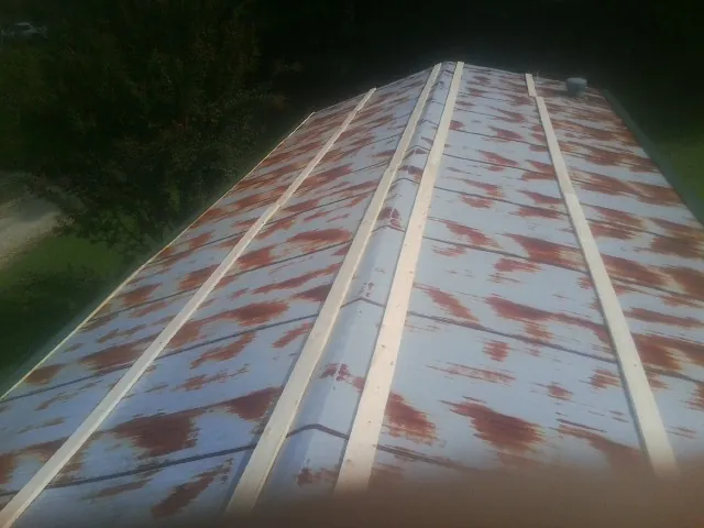 Rusted metal roof panels with new wood purlins before replacement — Storm Damage Roof Repair in Valles Mines by Roofing Brothers